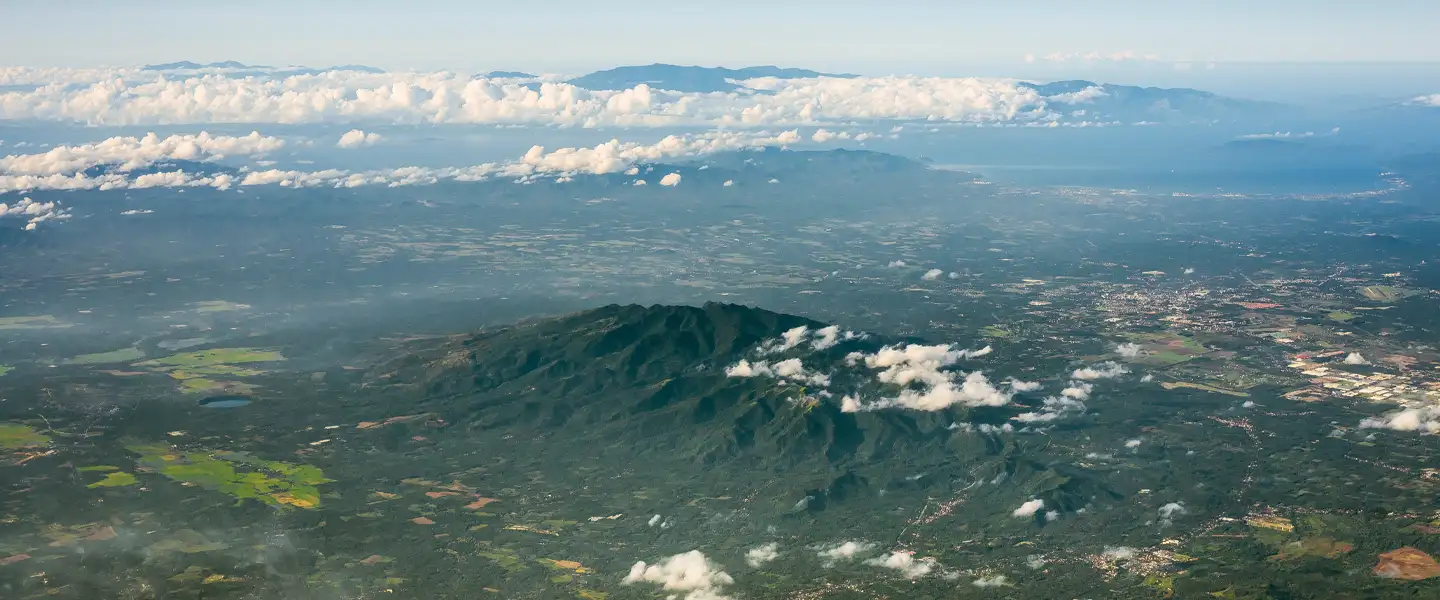 A wide, scenic landscape view of Batangas, highlighting expanding provincial business hubs, modern master-planned communities, and coastal growth areas.