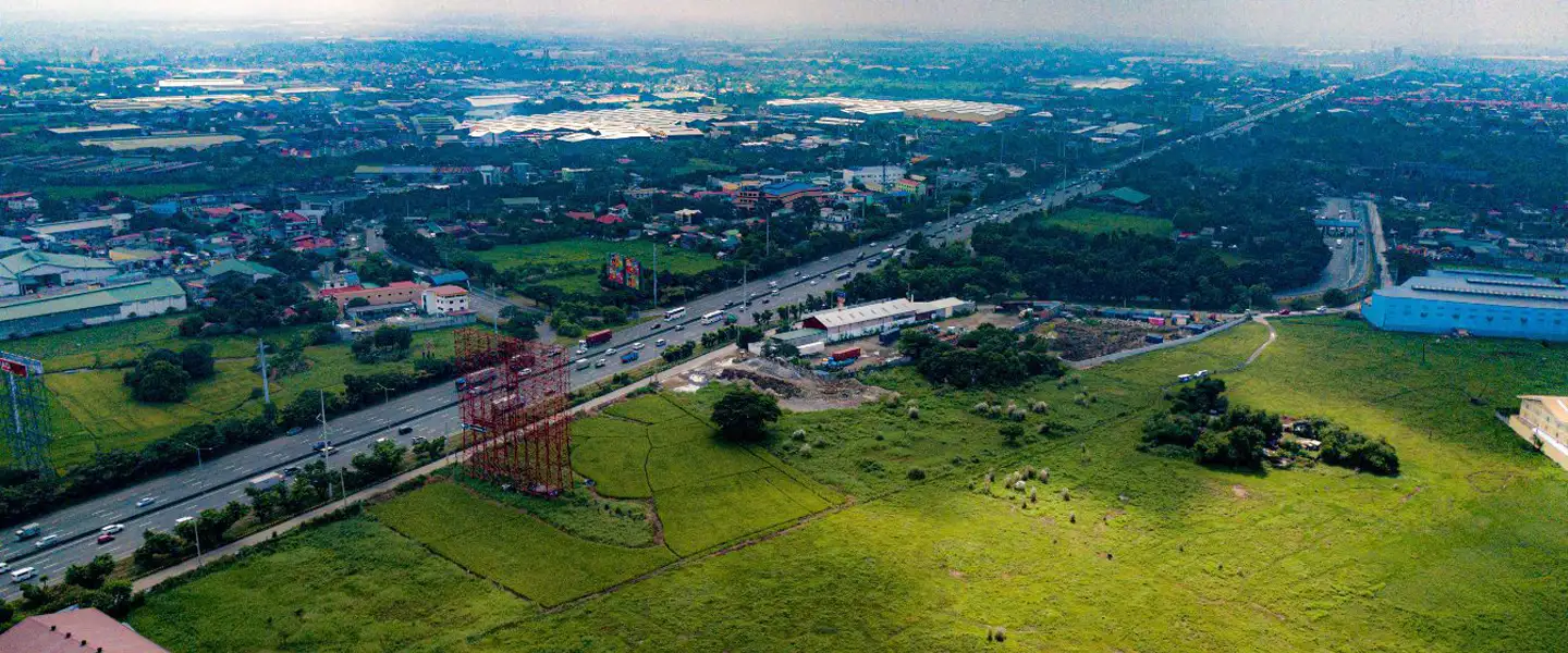 A broad landscape look at Bulacan, capturing the vibrant mix of progressive local infrastructure, growing commercial blocks, and suburban residential communities.