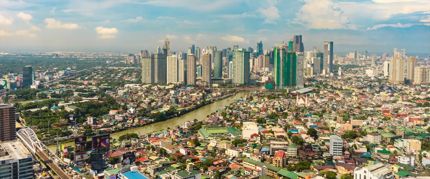 A wide-angle view of the modern high-rise condominiums and commercial towers in the Mandaluyong City skyline.