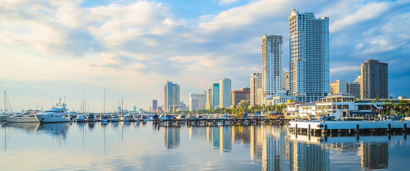 A wide panoramic view of Pasay City's vibrant skyline, highlighting master-planned bayfront developments, high-rise condominiums, and commercial entertainment hubs.