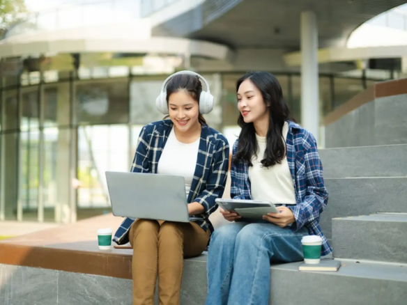 Two college students studying on a university campus in Taft Manila